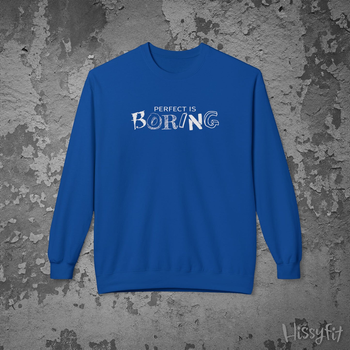 Blue sweatshirt with 'PERFECT IS BORING' text on a textured gray background