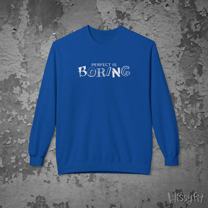 Blue sweatshirt with 'PERFECT IS BORING' text on a textured gray background